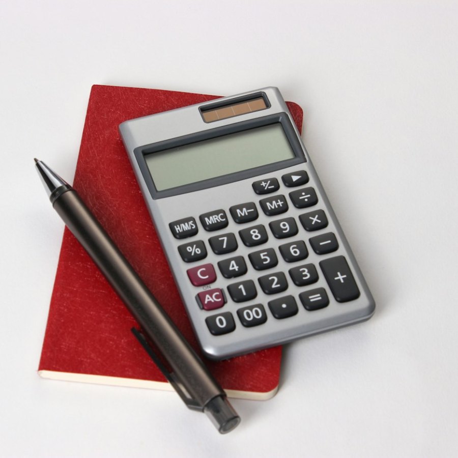 Calculator and pen – legal costs and Legal Aid